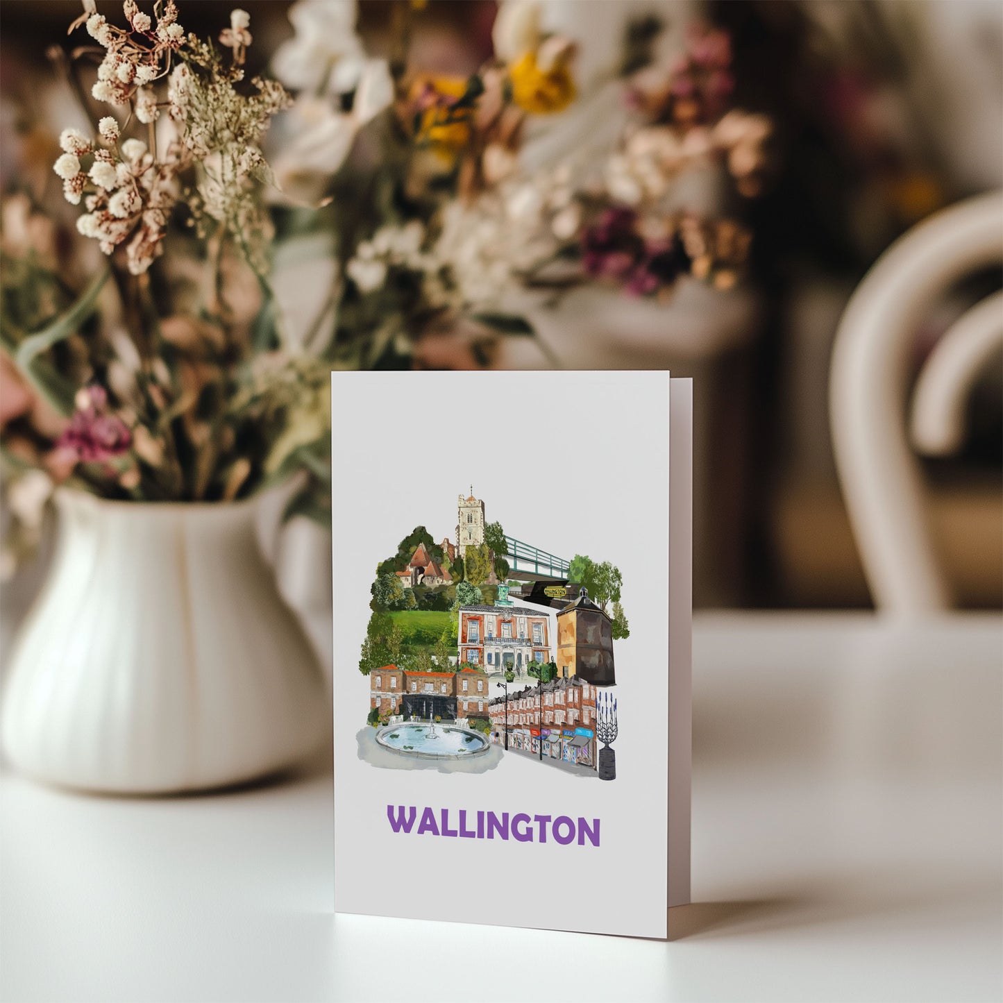 Wallington greeting card on a table with a bunch of flowers in the background
