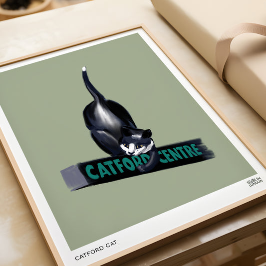 Framed artwork of a cat with 'Catford Centre' text on a green background