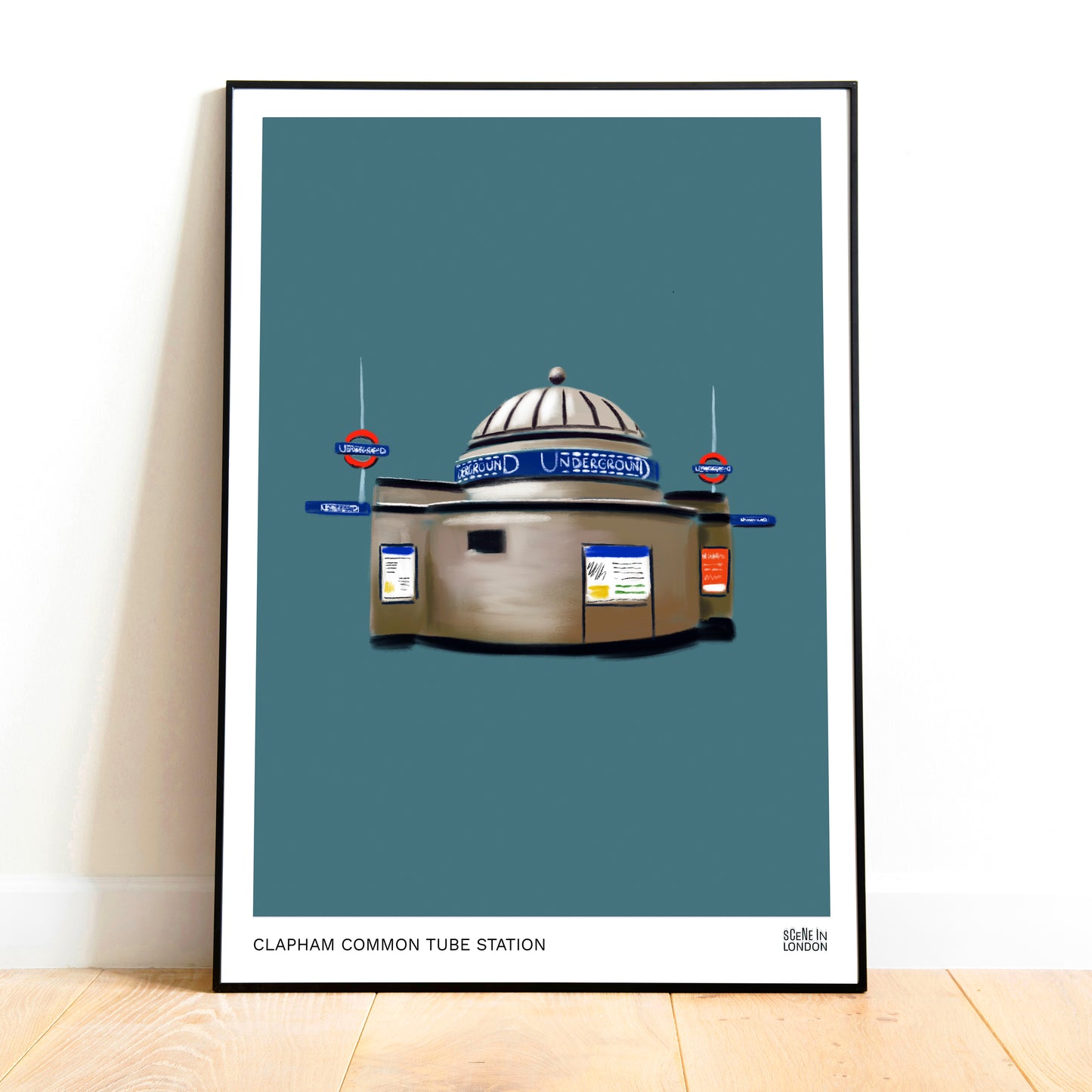 Framed artwork of Clapham Common tube station on a blue background