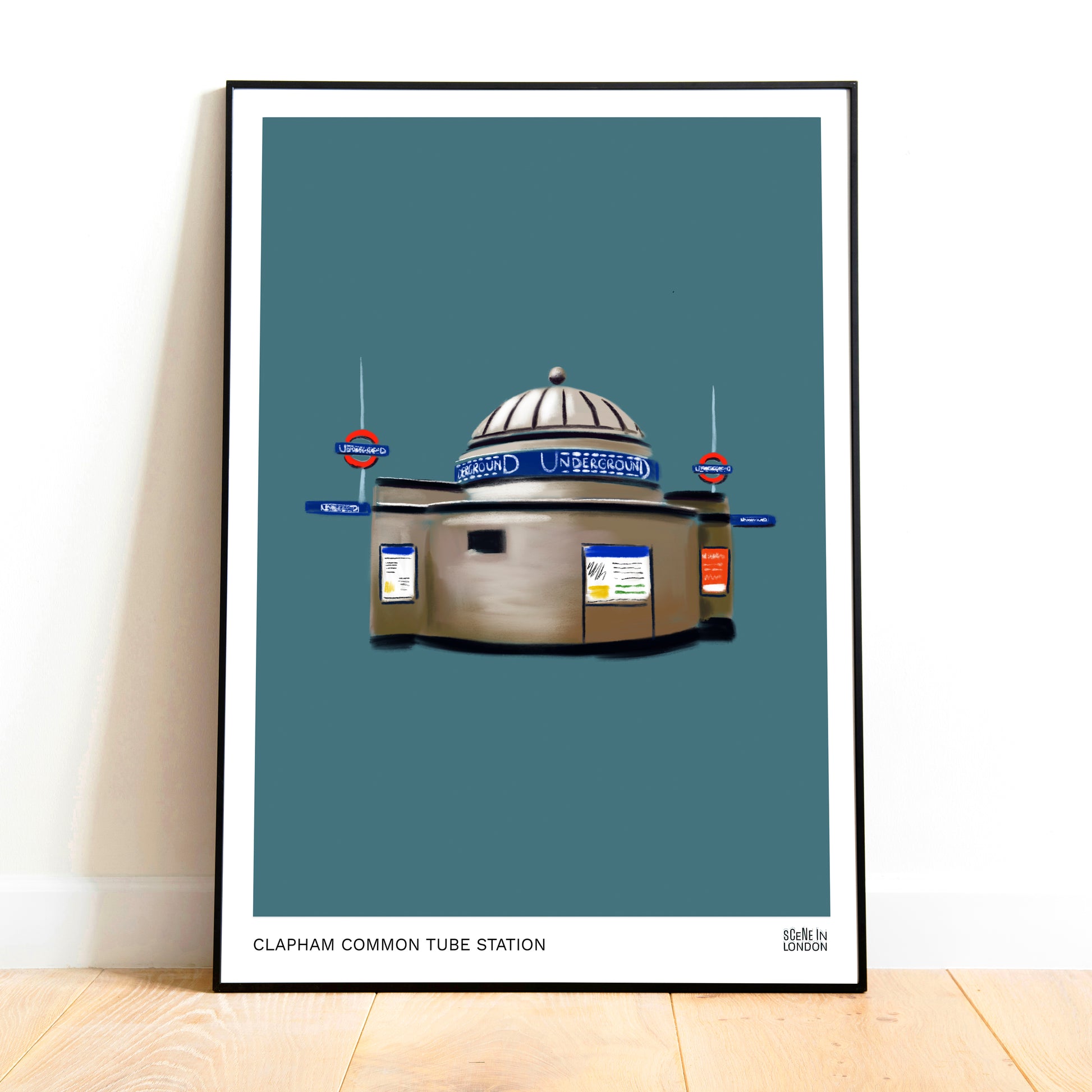 Framed artwork of Clapham Common tube station on a blue background