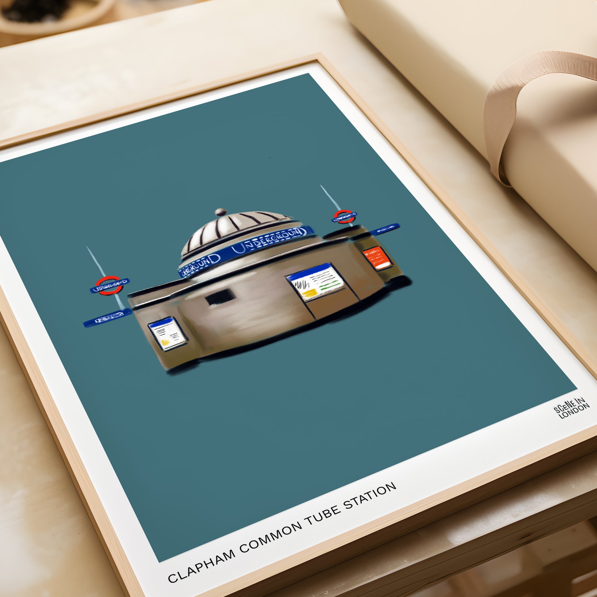 Framed artwork of Clapham Common Tube Station on a teal background