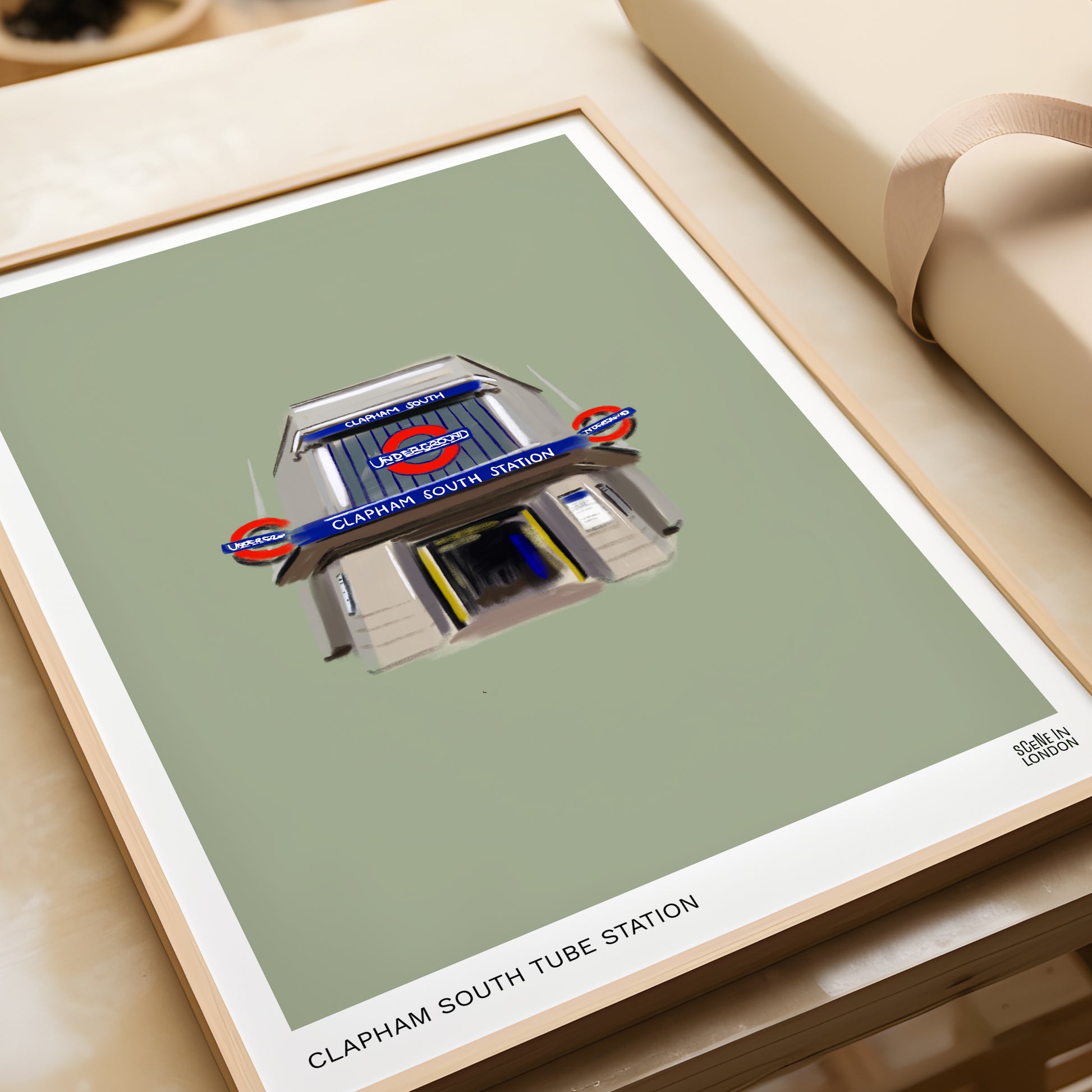 Framed artwork of Clapham South tube station on a green background