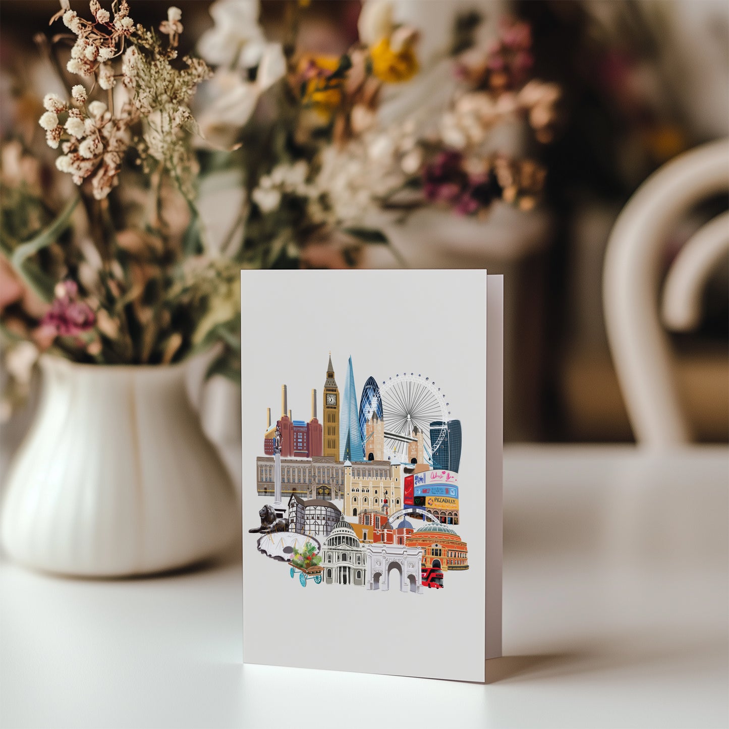Card with London cityscape illustration on a table with flowers in the background