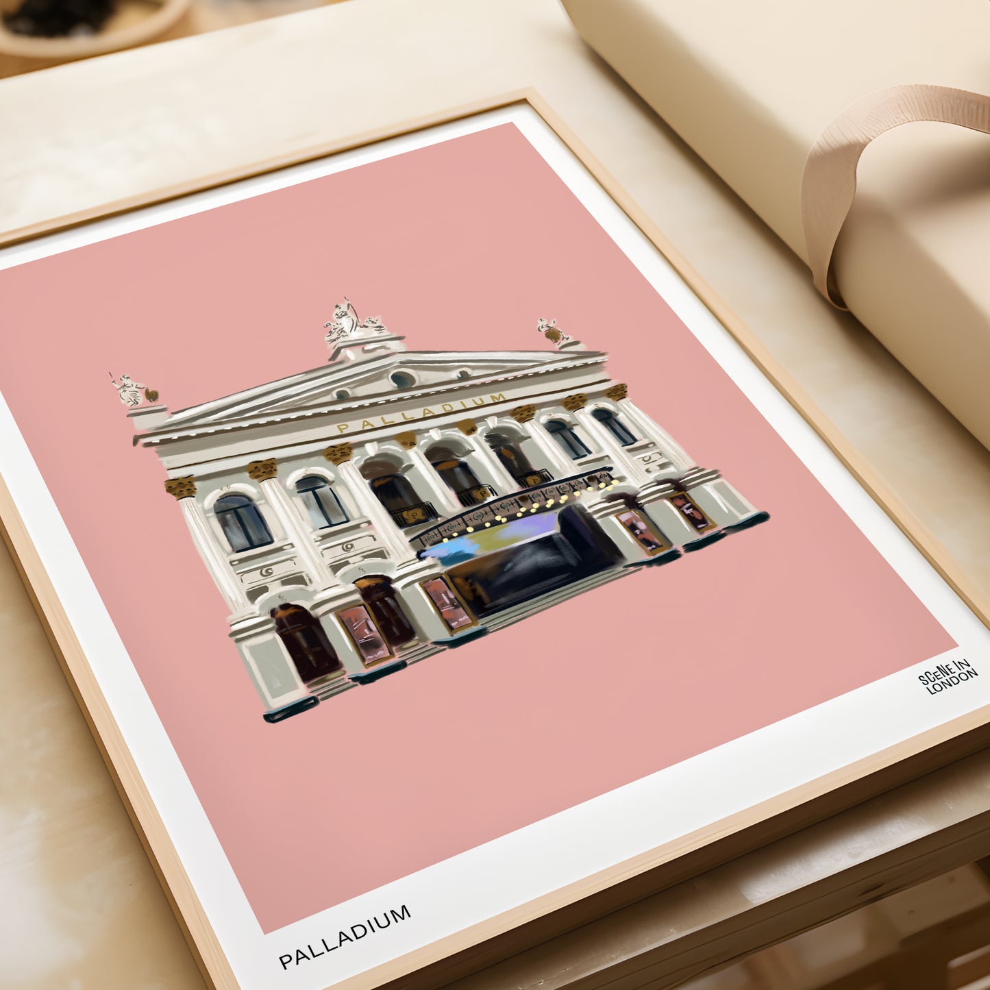 Framed artwork of the Palladium Theatre on a pink background